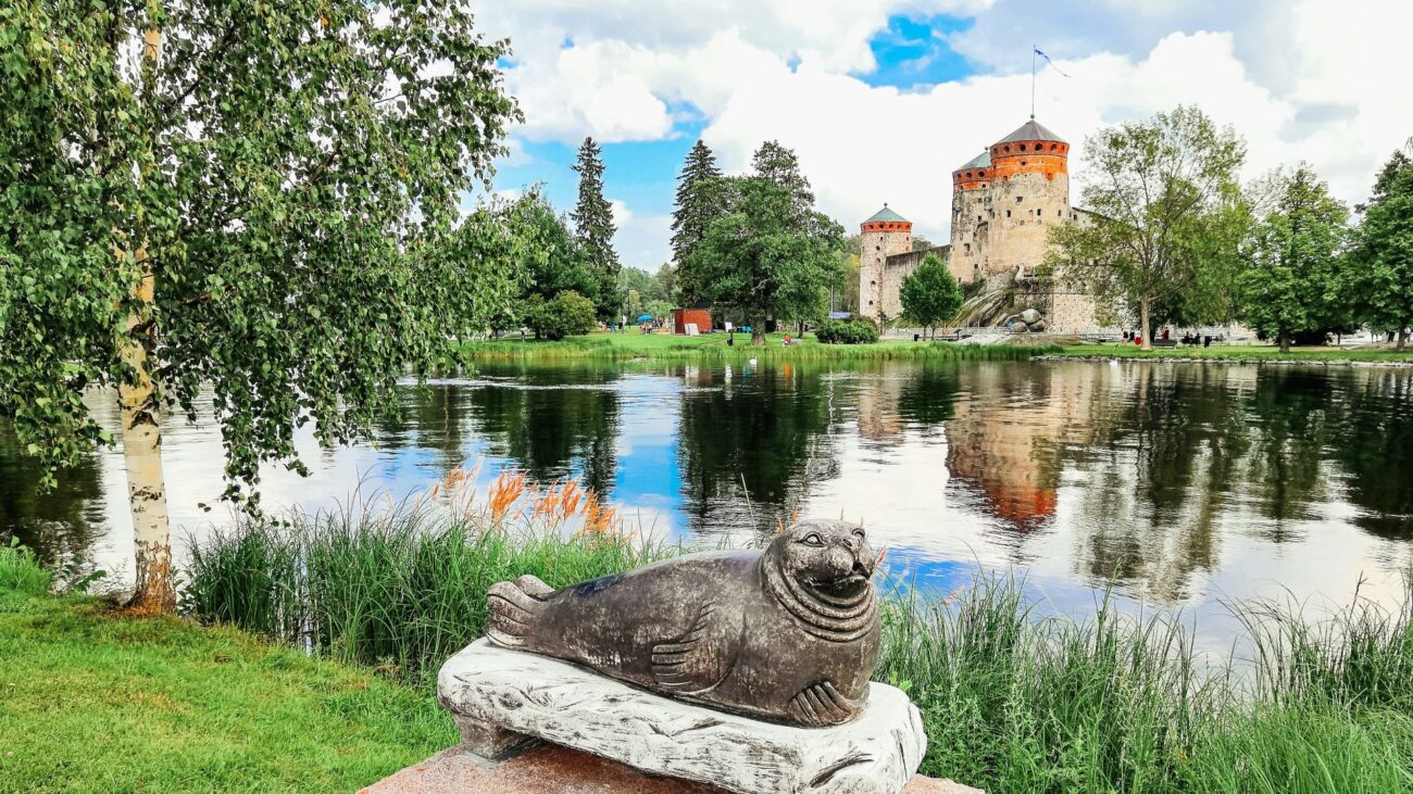 Schloss Olavinlinna mit Teich und Ringelrobbenstatue 